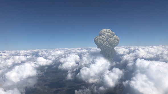 Large mushroom cloud explosion or volcano over Clouds