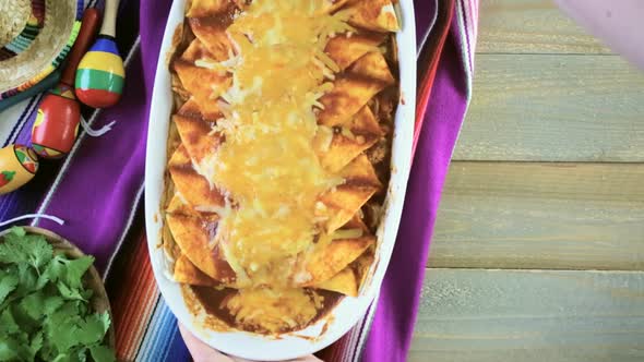 Homemade chicken enchiladas garnished with green onions and cilantro in a white casserole dish.