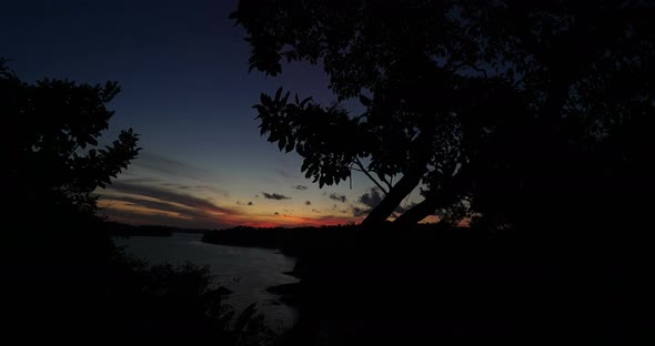 Beautiful Sunset Time Lapse with Trees, Sun Come Into Ocean, Over Water, Sky Become Red