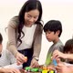 Asian School Teacher Assisting Elementary Students in Science Classroom - VideoHive Item for Sale