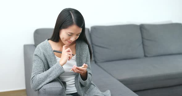 Woman Writing the Sticky Note at Home