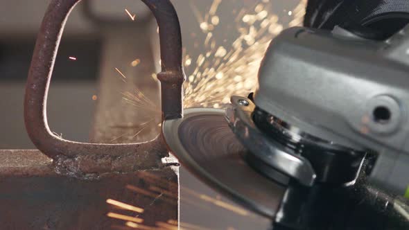 Slow motion of a metal grinder during work with sparks flying