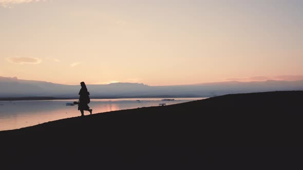 Silhouette Of Man Walking Through Icelandic Landscape