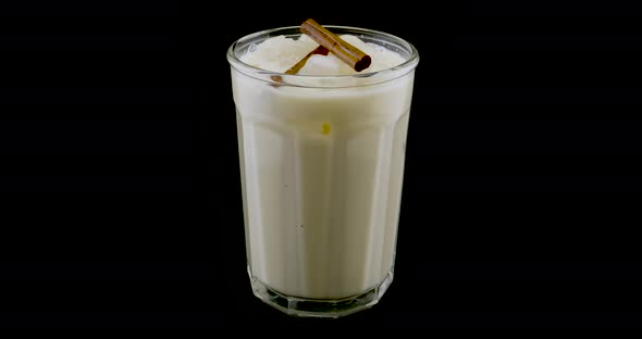 Orchata water with cinnamon on a turntable. Mexican drink.