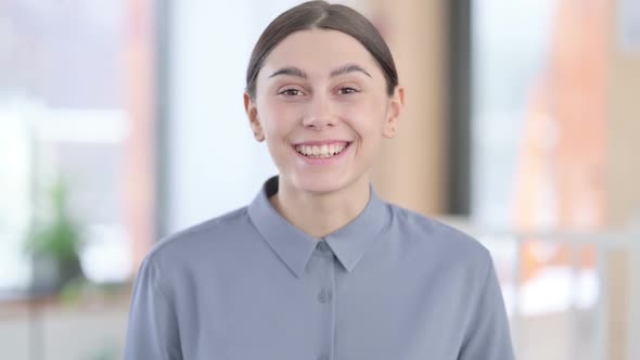 Portrait of Young Latin Woman Talking on Online Video Call