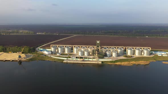 Modern Grain Silos At The Field Near The River