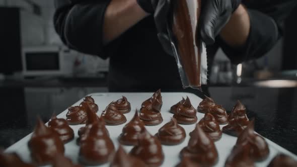 Chef Chocolatier Makes Sweets From Melted Chocolate with Pastry Bag in Slow Motion, Raw Materials