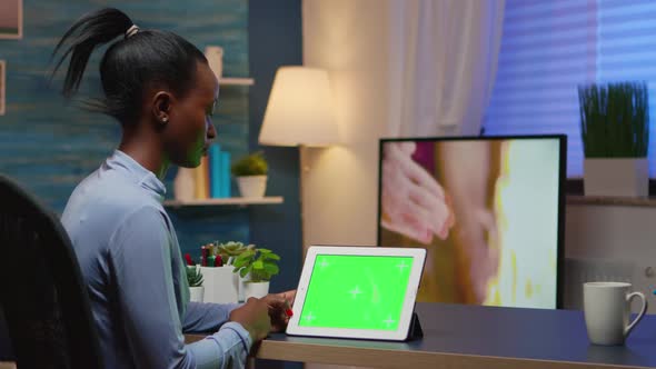 Focused Black Manager Woman Looking at Tablet with Green Screen