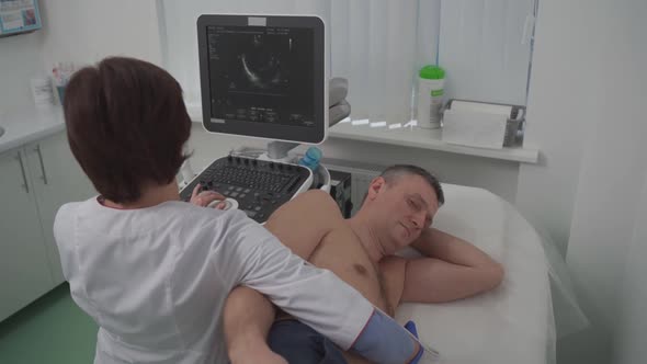 Doctor Doing a Doppler Sonography a Male Patient in a Cardiology Clinic