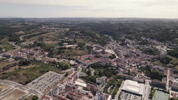 Alcobaça city, aerial establishing shot. Sprawling charming cityscape with famous monastery