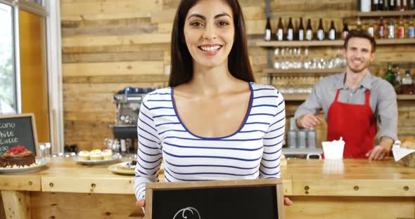 Woman Standing with Open Sign Board in Cafe 4k