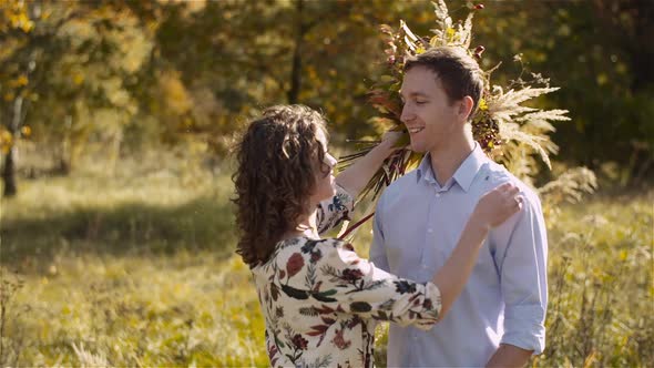 Young Couple in Love Walking on Meadow in Summer - Togetherness Concept.