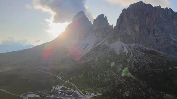 Aerial view of Dolomites peak in Val Gardena, Italy, with sun flare. 4k