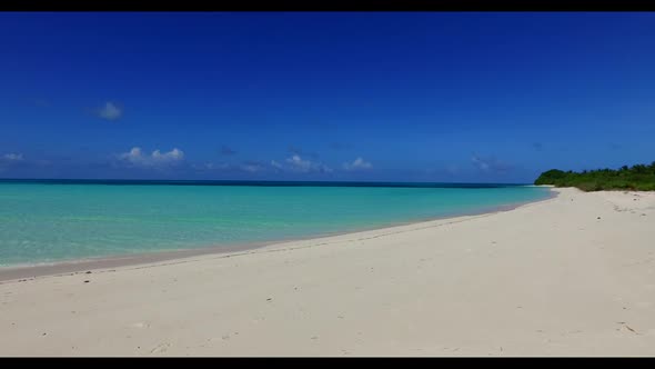 Aerial drone shot scenery of relaxing island beach journey by blue water with white sandy background