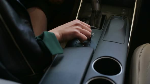 Closeup of a Girl Sitting in Her New Car at a Car Dealership