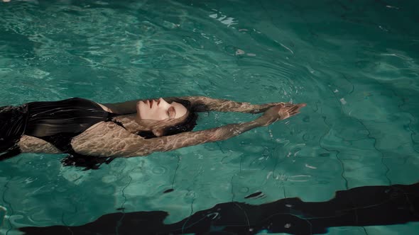 The Woman Swims in the Pool