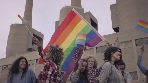 Protestors Waving a Rainbow Coloured Flag at a Street Parade