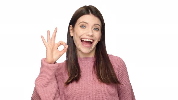 Portrait of Joyous Adult Woman in Cheerful Mood Gesturing Ok Sign Meaning Good Choice or Approval