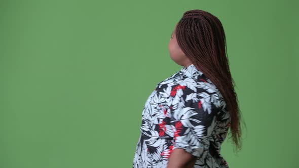 Overweight Beautiful African Woman Against Green Background