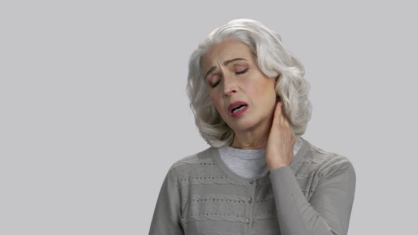 Old Lady Touching Her Neck Because of Pain