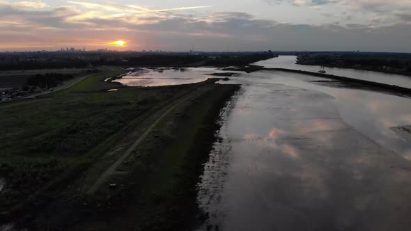 reflection of clouds during sunset at a fresh water tidal area in the Netherlands