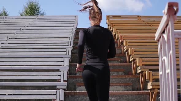 Slim Woman Running in City Stadium