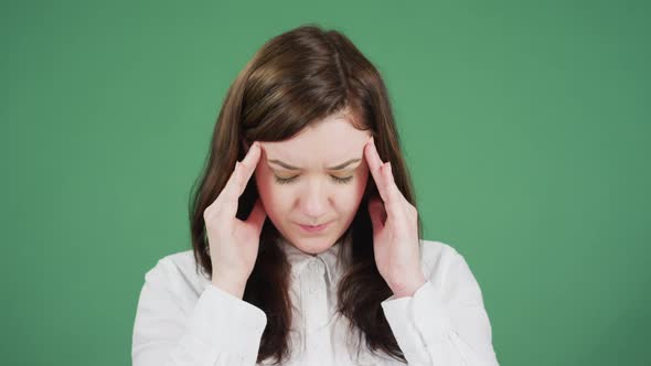 Young woman massaging her temples and forehead