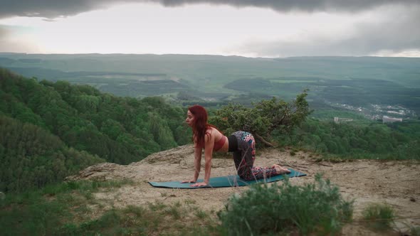 Athletic Woman Practices Stretching on Top Mountain Girl Goes in Sports Outdoors