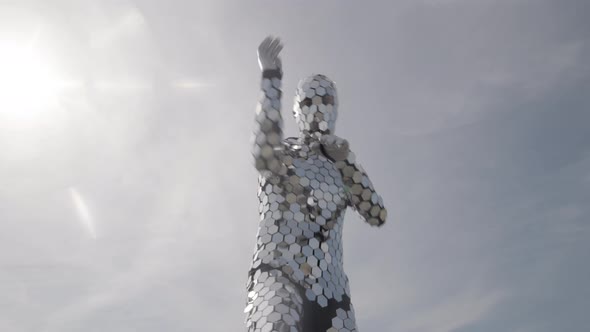 Sparkling Discosuit Man Dancing with Clouds Behind