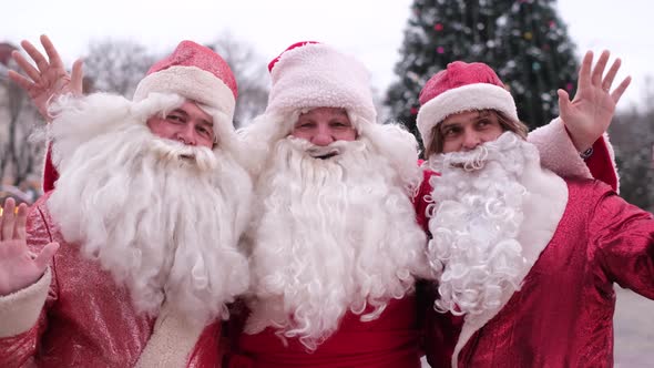 Three Santa Clauses Walk the Streets of New York
