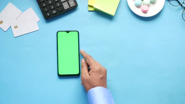 Top View of Man Hand Using Smart Phone on Office Desk