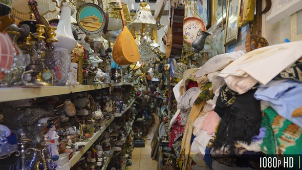 Trinkets, antiques, and vintage stuff for sale on store shelves at a marketplace