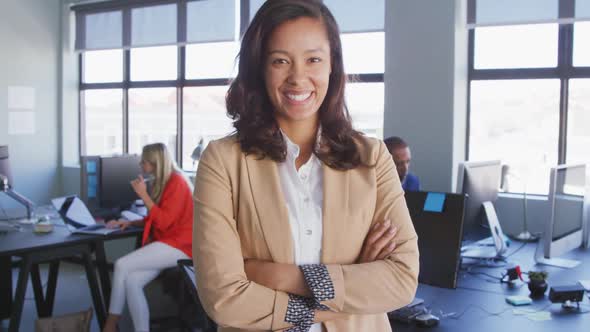 Businesswoman looking at camera in modern office