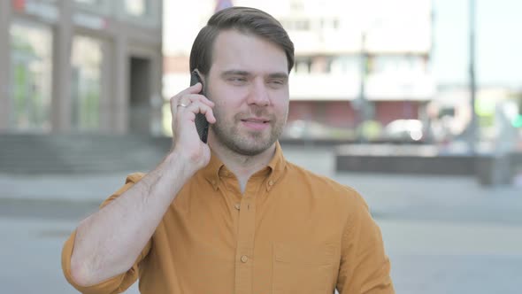 Portrait of Young Man Talking on Phone Outdoor