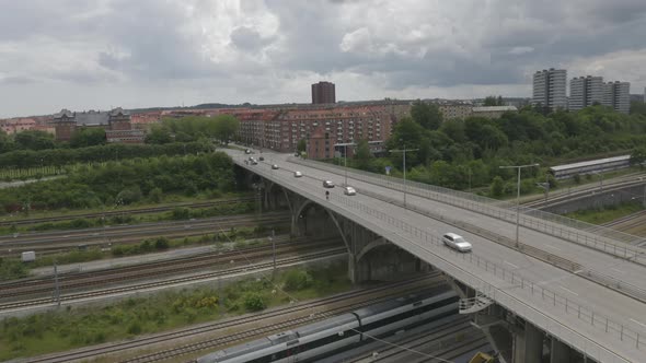 Railroad Under a Bridge with Fast Cars Passing Through