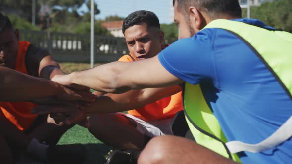 Soccer players motivating on the field