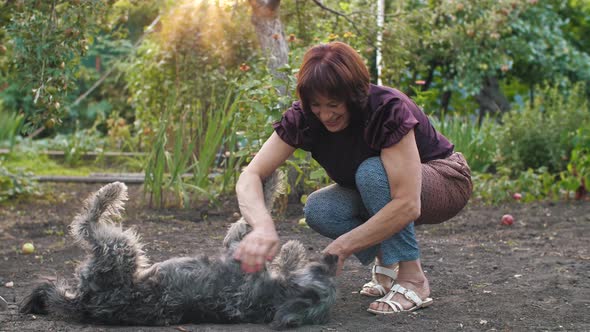 Woman with Her Dog Playing