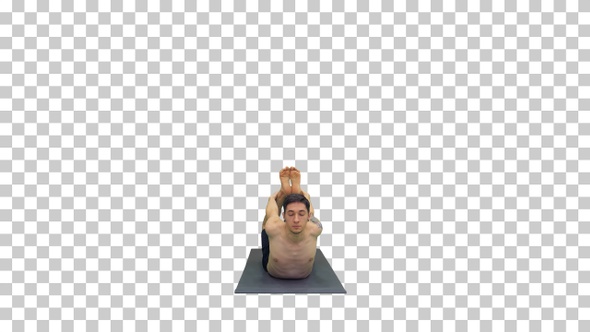 Shirtless Athletic Man Demonstrates a Yoga Bow Pose on Mat