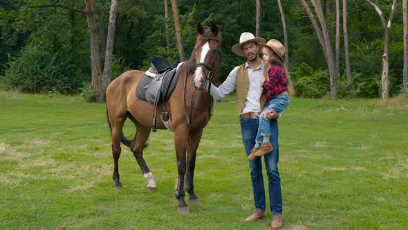 Cowboy and His Daughter with a Horse on the Lawn