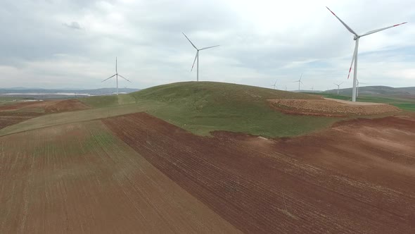 Wind Power Plant on Edge of Brown Treeless Fields in Vast Plain