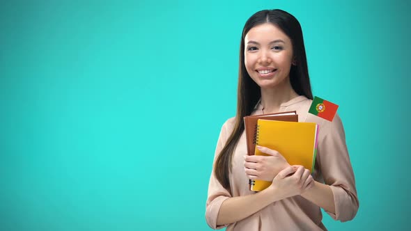 Cheerful Woman Holding Portuguese Flag Book, Education Abroad, Learning Language