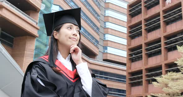 Asian woman get graduation gown