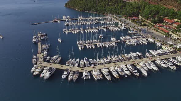 Yachts docked on pier in yacht club in marine bay. Aerial view of yacht club