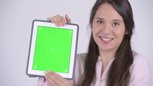 Face of Young Happy Multi-ethnic Businesswoman Showing Digital Tablet