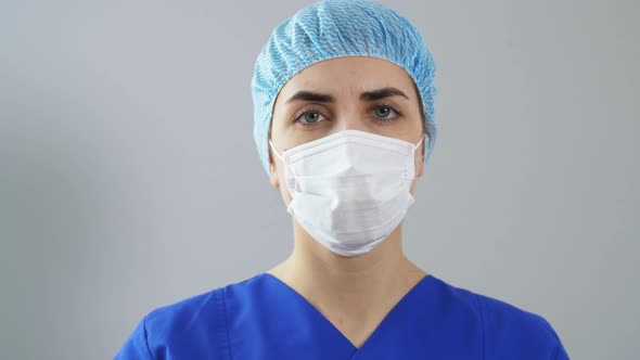 Doctor in Face Mask with Medicine in Syringe