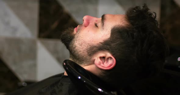 Hairdresser washing clients hair