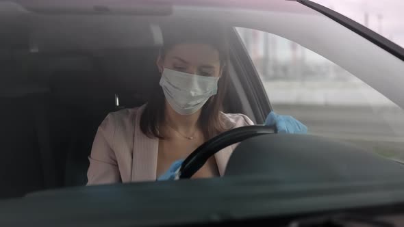 Hypochondriac Woman is Disinfecting Steering Wheel of Her Auto Fear of Infection