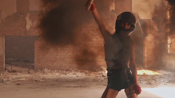 Biker in Leather Shorts and Top Holding Smoke Bomb