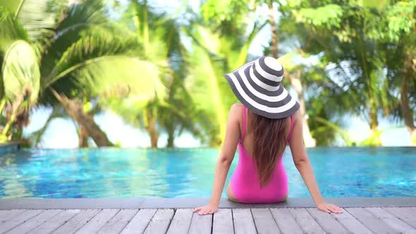 Young asian woman enjoy around outdoor swimming pool for leisure