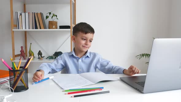 Kid Via Laptop Listening Teacher During Online Studying at Home